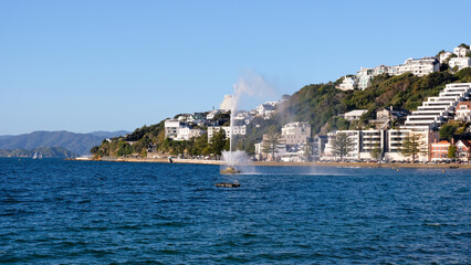 Scenic view of water fountain spraying in harbour of Oriental Bay in capital city of Wellington, New Zealand Aotearoa