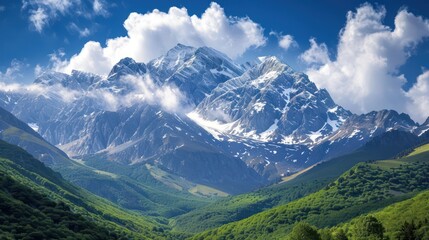Fototapeta premium Majestic snow-capped mountain peak towering over lush green valleys, under a bright blue sky with fluffy clouds. Concepts. nature, landscape, scenery, travel, adventure, hiking.