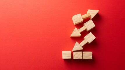 Wooden blocks with a declining graph and arrow down on a red background, representing market analytics for economic downturn. Flat lay. High quality, no realistic photo details.