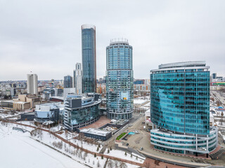 Obraz premium Yekaterinburg city with Buildings of Regional Government and Parliament, Dramatic Theatre, Iset Tower, Yeltsin Center, panoramic view at winter sunset.