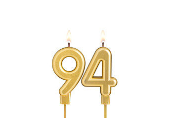 Birthday candle number 94 on white background