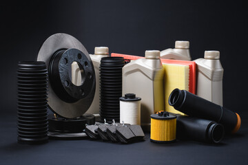 Auto parts on a black background. New spare parts for car repair and service.