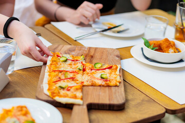 People eating flatbread style pizza