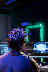 Engineer with EEG headset on programming brain transfer into computer virtual world, merging with...