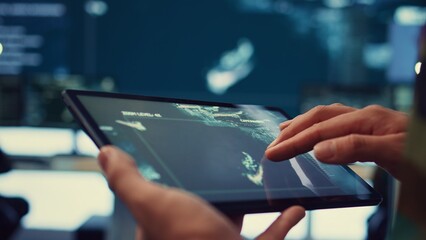 Special operations engineer following enemy warships or submarines to ensure safety within national territory. Navy IT specialist protecting the coast from hostile vessels. Close up. Camera B.