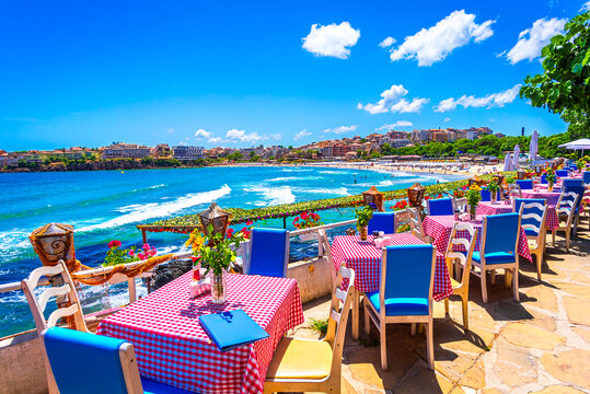 Sozopol, Burgas Province, Bulgaria: Empty tables on a terrace overlooking the sea. Cafe with sea view. Beautifull seascape at black sea. Summer destination