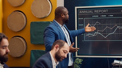 Digital marketing team attending an innovation and brainstorming meeting in boardroom, analyzing sales reports to understand market trends. Working on enterprise growth solutions. Camera A.