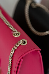 Metal chains handles on women's handbags.