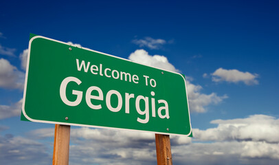 Welcome To Georgia Green Road Sign Over Blue Sky with Some Clouds. © Andy Dean