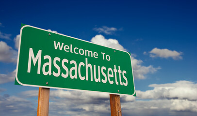 Welcome To Massachusetts Green Road Sign Over Blue Sky with Some Clouds. © Andy Dean