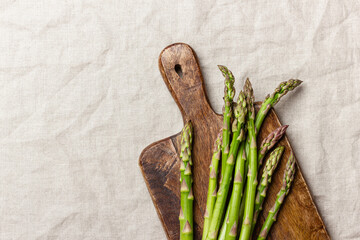 Green asparagus on a wooden cutting board