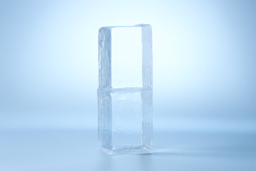 Blocks of clear ice on light blue background