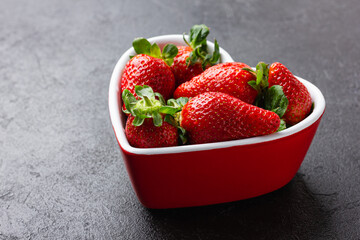 Fresh strawberries in heart bowl