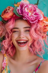 Naklejka premium A summer fashion portrait of a happy laughing woman with pink hair surrounded by fresh colorful flowers on blue background.