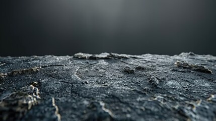 A black and white photo of a rocky surface with a grey sky in the background.
