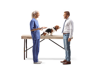 Female veterinarian talking to a man with a basset hound dog