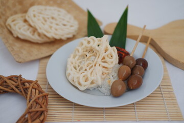 rice with skewered quail eggs and crackers on wood background. Selective focus.
