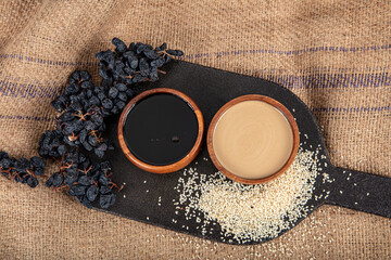 Tahini (sesame paste) and Molasses in wooden bowl. Local name; Turkish Tahin Pekmez. Healthy option...