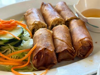 Crispy egg rolls with cucumber and carrot sides