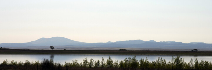 Ultra-wide panorama of dawn light on Lake Thirteen at Maxwell National Wildlife Refuge in New Mexico