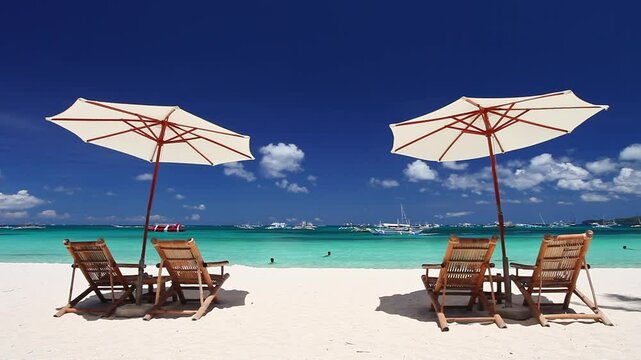 Sun umbrellas and beach chairs on tropical beach. Summer vacation. Boracay