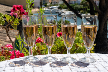 Summer party, French brut rose champagne sparkling wine in flute glasses in yacht harbour of Port Grimaud near Saint-Tropez, French Riviera vacation, Var, France