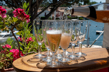 Summer party, French brut rose champagne sparkling wine in flute glasses in yacht harbour of Port Grimaud near Saint-Tropez, French Riviera vacation, Var, France