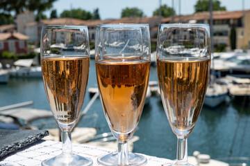 Summer party, French brut rose champagne sparkling wine in flute glasses in yacht harbour of Port Grimaud near Saint-Tropez, French Riviera vacation, Var, France