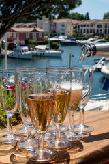 Summer party, French brut rose champagne sparkling wine in flute glasses in yacht harbour of Port Grimaud near Saint-Tropez, French Riviera vacation, Var, France