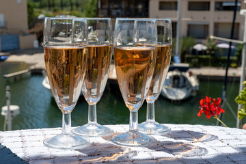 Summer party, French brut rose champagne sparkling wine in flute glasses in yacht harbour of Port Grimaud near Saint-Tropez, French Riviera vacation, Var, France