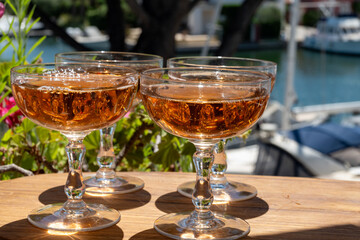 Summer party, French brut rose champagne sparkling wine in coupe glasses in yacht harbour of Port Grimaud near Saint-Tropez, French Riviera vacation, Var, France