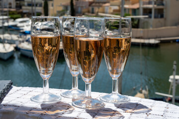 Summer party, French brut rose champagne sparkling wine in flute glasses in yacht harbour of Port Grimaud near Saint-Tropez, French Riviera vacation, Var, France