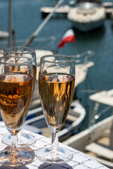 Summer party, French brut rose champagne sparkling wine in flute glasses in yacht harbour of Port Grimaud near Saint-Tropez, French Riviera vacation, Var, France