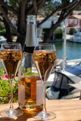 Summer party, French brut rose champagne sparkling wine in flute glasses in yacht harbour of Port Grimaud near Saint-Tropez, French Riviera vacation, Var, France