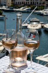 Glasses of cold rose gris Cote de Provence wine in yacht harbour of Port Grimaud, summer vacation on French Riviera in Provence, France