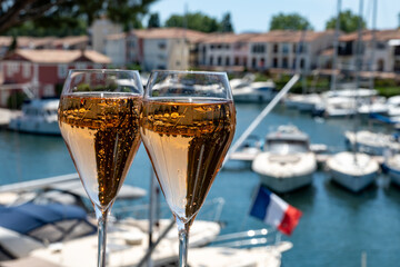Summer party, French brut rose champagne sparkling wine in flute glasses in yacht harbour of Port Grimaud near Saint-Tropez, French Riviera vacation, Var, France