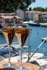 Summer party, French brut rose champagne sparkling wine in flute glasses in yacht harbour of Port Grimaud near Saint-Tropez, French Riviera vacation, Var, France