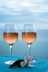 Summer time in Provence, two glasses of cold rose wine with blue sea view on background, French Riviera near Menton, south of France