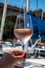 Obraz premium Party with rose wine on yacht boat anchored in port la Rague, Gulf of La Napoule, in Provence, two glasses of cold rose wine, French Riviera near Cannes, south of France