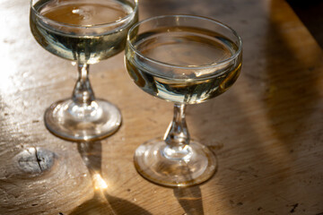 Sparkling wine, cava or champagne in two coupe glasses on wooden table, French Riviera is summer, France