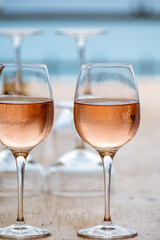 Summer time in Provence, two glasses of cold rose wine with blue sea view on background, French Riviera near Menton, south of France