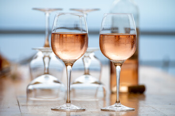 Summer time in Provence, two glasses of cold rose wine with blue sea view on background, French Riviera near Menton, south of France