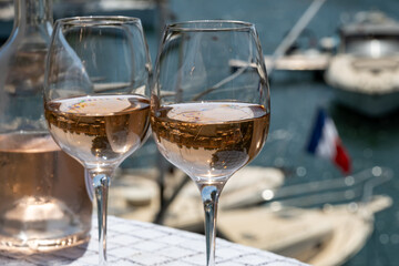 Glasses of cold rose gris Cote de Provence wine in yacht harbour of Port Grimaud, summer vacation on French Riviera in Provence, France
