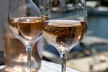 Glasses of cold rose gris Cote de Provence wine in yacht harbour of Port Grimaud, summer vacation on French Riviera in Provence, France