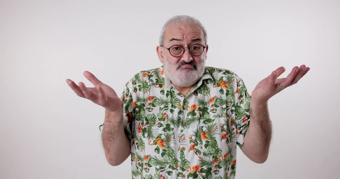 Confused, doubt and portrait of senior man shoulder shrugging and raise arms isolated on white studio background. Clueless, dont know and mature male person with question, whatever and hand gesture