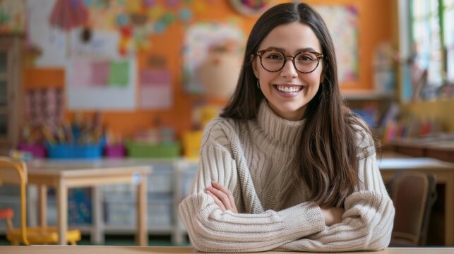 A delighted teacher sits in a vibrant classroom filled with educational materials, with children learning in the background, creating a supportive and joyful educational environment.