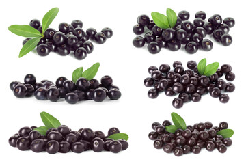 Set of acai berries with green leaves isolated on white