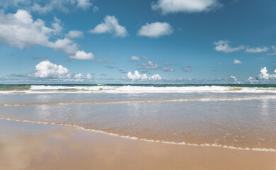 Beach called Porto de Galinhas with lots of waves and sky with clouds on the coast of Brazil.