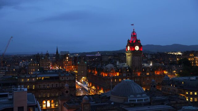 Aerial night timelapse of Edinburgh castle and clock tower in Old town of Edinburgh in Scotland, UK