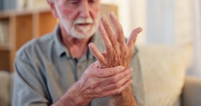 Senior man, pain and touch hand for injury with arthritis problem, inflammation and healthcare in nursing home. Elderly person, wrist massage and hurt for osteoporosis, fibromyalgia or muscle cramps